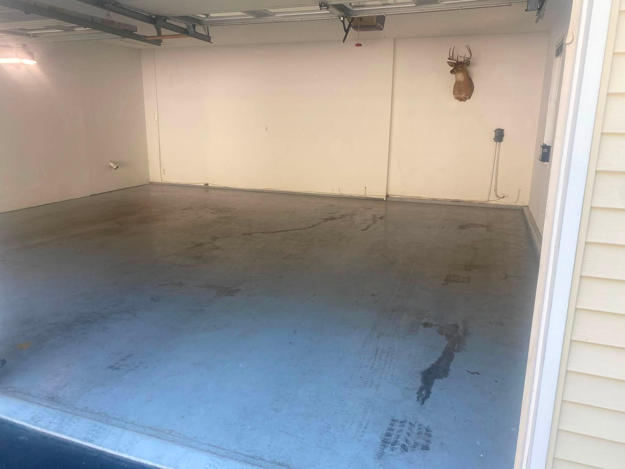 Bare unfinished concrete garage floor before coating