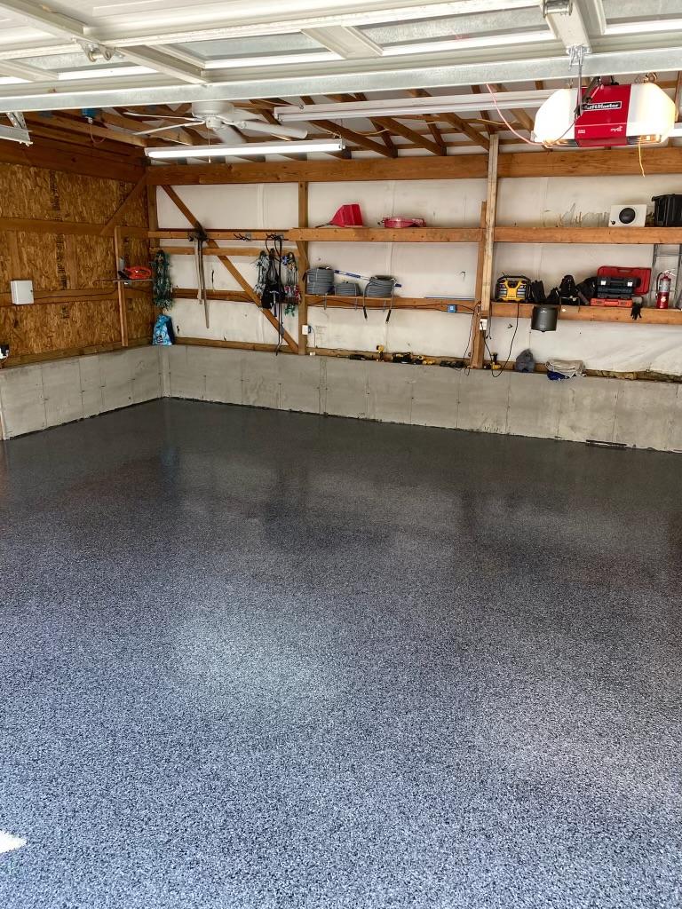 High-gloss grey flake epoxy floor in a workshop garage