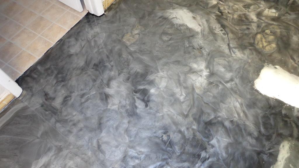 Metallic epoxy floor with black and pearl swirl finish