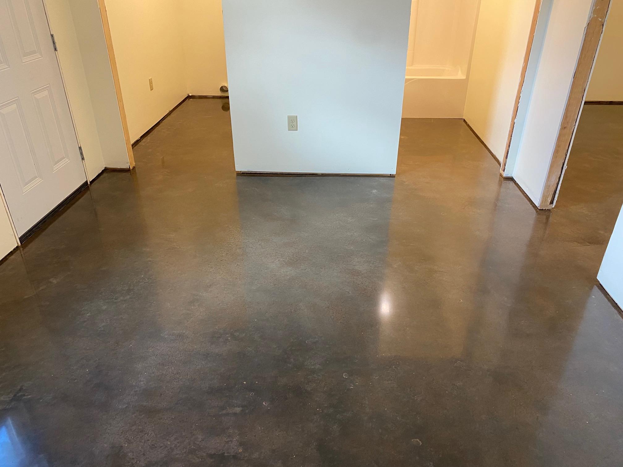 Metallic epoxy coating freshly applied across the room